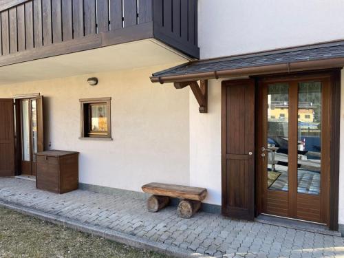 a wooden bench sitting outside of a house at Bormio and Livigno house in Isolaccia