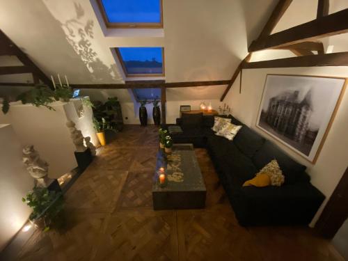 an overhead view of a living room with a couch at The Castle Loft - Pascal's Angels in Clemency