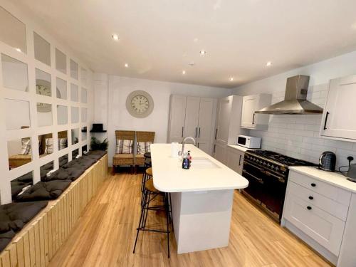 a kitchen with white cabinets and a white counter top at Beach House By Sasco in Blackpool
