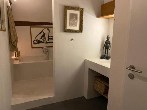 a bathroom with a sink and a bath tub at The Castle Loft - Pascal's Angels in Clemency