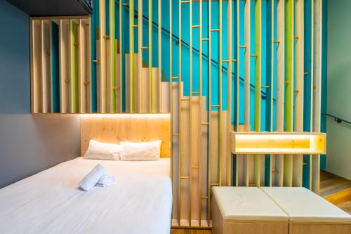 a bedroom with a bed and a staircase at The People - Strasbourg in Strasbourg
