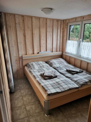 a bedroom with a bed in a room with a window at Ferienhaus Mühlberg 4 in Braunschwende