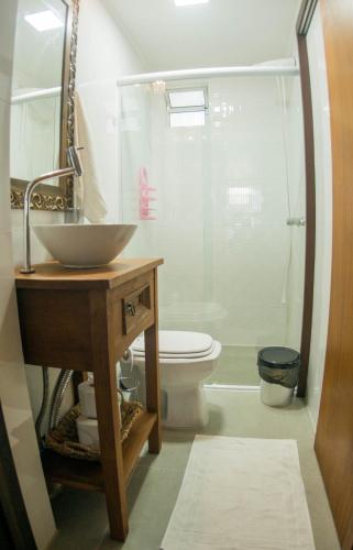 a bathroom with a sink and a toilet at Casa container in Tramandaí
