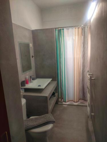 a bathroom with a sink and a toilet and a shower at Home4U, just 7km from airport in Markopoulo