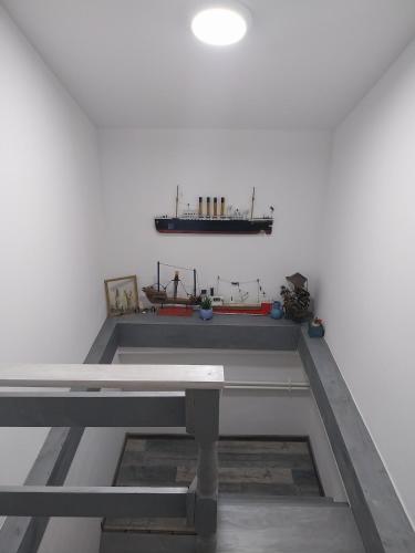 a table in a room with a white wall at Olive garden house in Petrovaradin