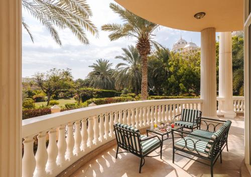 a balcony with two chairs and a table on it at Kempinski Hotel & Residences Palm Jumeirah in Dubai