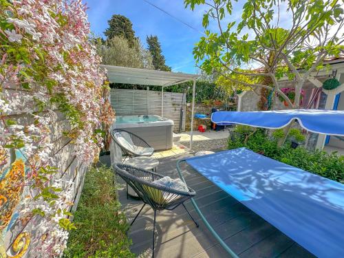 a patio with a table and chairs and a pool at Beachfront House with Private Jacuzzi and Garden Zadar in Zadar