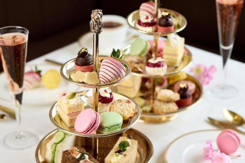 a table topped with plates of desserts and glasses of champagne at The Ritz-Carlton, Tysons Corner in Tysons Corner
