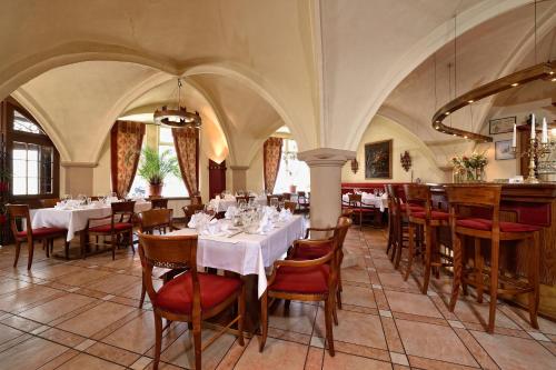 路德斯塔德艾斯勒本的住宿－格拉夫·馮·曼​​斯費爾德酒店，餐厅内带桌椅的用餐室