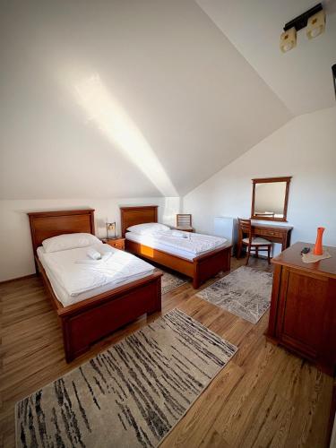 a bedroom with two beds and a table and a chair at Penzion Urban in Havířov