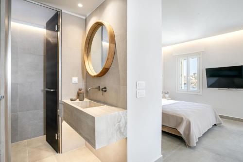a bathroom with a sink and a mirror at Kythnos Blue - Suite 4 Luxurious, Sea Front in Kithnos