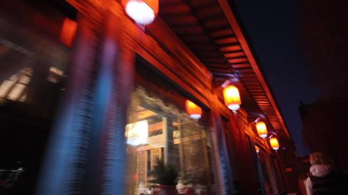 a blurry picture of a building at night with lights at Datong Yunzhong Traditional Courtyard in Datong
