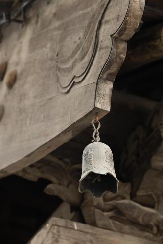 a bell hanging from the ceiling of a building at Datong Yunzhong Traditional Courtyard in Datong