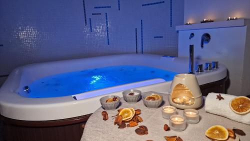 a bathroom with a bath tub with candles and oranges at Saracen Sands Hotel & Congress Centre - Palermo in Isola delle Femmine