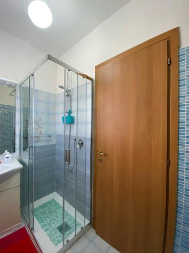 a shower with a glass door in a bathroom at Pierina in Lucca
