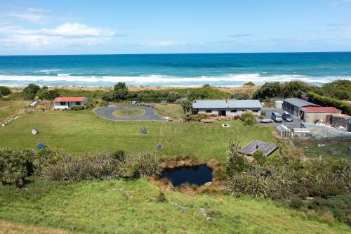 an aerial view of a house and the ocean at Southern Lights Retreat - Main House in Dunedin