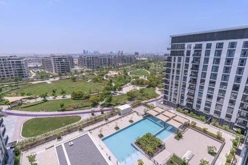 an aerial view of a large building with a pool at Free housekeeping visits during your stay - StayShort - Chic 1-Bed for 4 in Prime Dubai Hills Location in Dubai