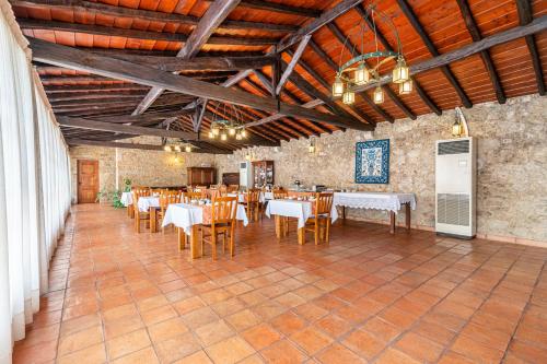 a dining room with tables and chairs in a building at Quinta de Malta in Durrães