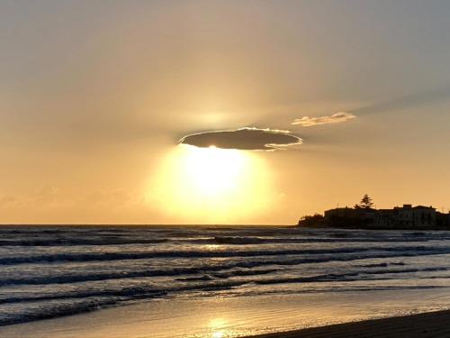 a cloud in the sky over a beach at Villa Quartarella - La bellezza nel silenzio - piscina in Michelica