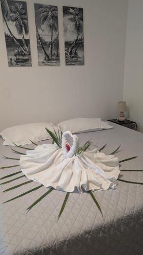 a white bed with a white towel on it at Enjoy Studio in Pointe-Noire