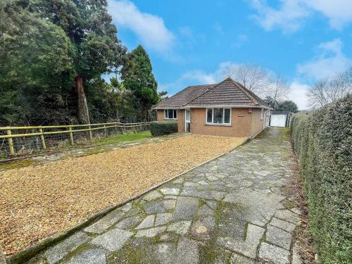a house with a stone walkway next to a fence at The Lockett Wonderful Large Bungalow Plympton, Plymouth Free Parking By STAE-Homes in Plymouth