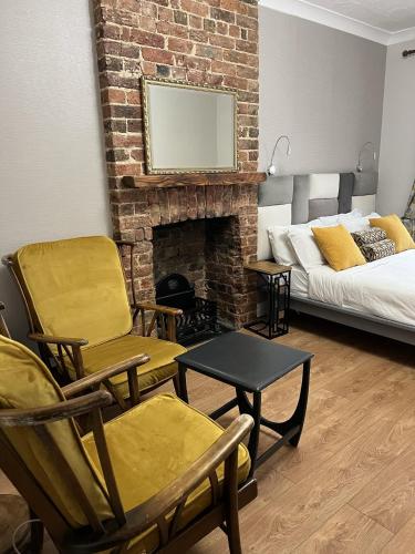 a living room with a couch and a fireplace at Astral Lodge in Hastings