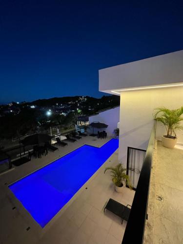 a swimming pool at night on a house at La bardot boutique Pousada in Búzios