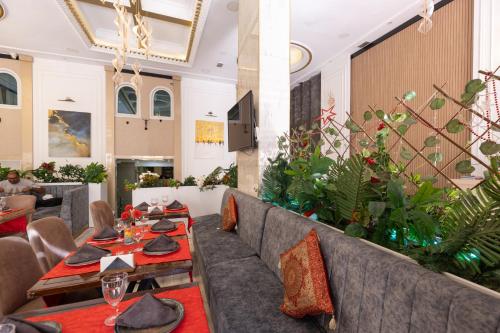 a restaurant with couches and tables and plants at Seher HOTEL in Istanbul