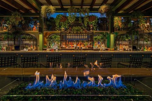 a bar with a fire pit in the middle at Perry Lane Hotel, a Luxury Collection Hotel, Savannah in Savannah