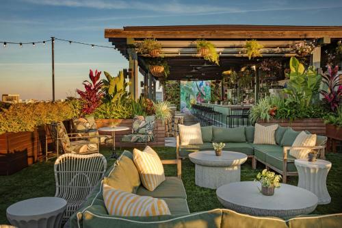 a patio with couches and tables and a bar at Perry Lane Hotel, a Luxury Collection Hotel, Savannah in Savannah
