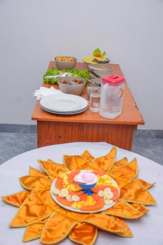 a table with a plate of chips on a table at Tedro home stay in Ampitiya