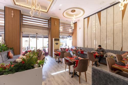 a restaurant with tables and chairs and people sitting at tables at Seher HOTEL in Istanbul