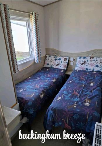 a small bedroom with a bed and a window at Buckingham Breeze Haven Caravan Hire Marton Mere Blackpool in Marton