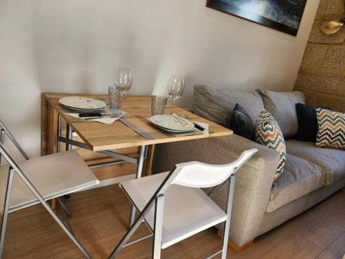 a living room with a table and a couch at Apartamento Rivera de Laxe in Laxe