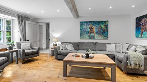 a living room with a couch and a table at Vine Cottage in Campden Station