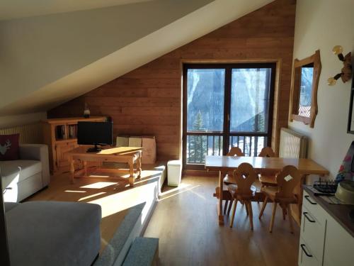 a living room with a couch and a table at Oasi di Pace vicino Sestriere in Champlas du Col