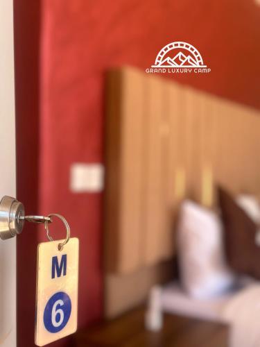 a key chain with the number on it in a room at Grand luxury rum in Wadi Rum