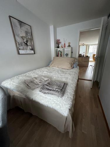 Un dormitorio con una cama con una manta blanca encima. en Beautiful view with a walking distance to everything, en Tromsø