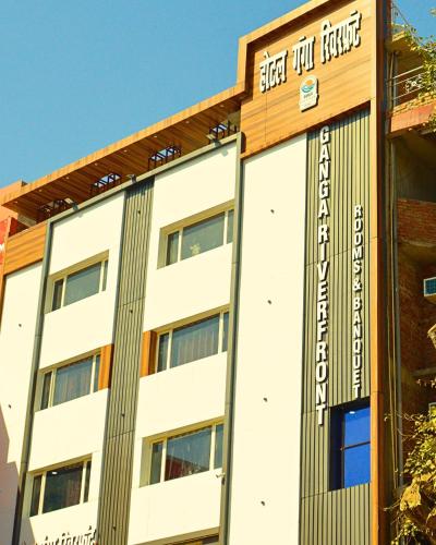 a building with a sign that reads hotel at Ganga Riverfront Rooms And Banquet in Prayagraj