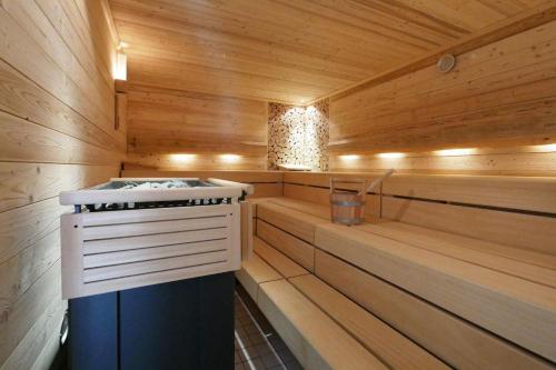 a sauna with a stove in a wooden cabin at Hotel-Restaurant Bibermühle GmbH in Tengen