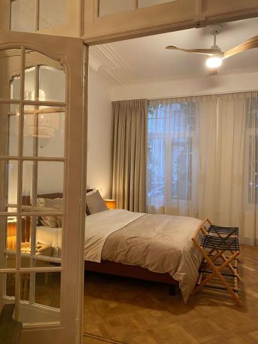 a bedroom with a large bed and a window at Completely renovated apartment in Antwerp
