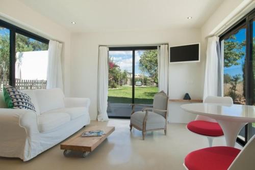 a living room with a white couch and a table at charming studio in the house of Envi's house in Sant Josep