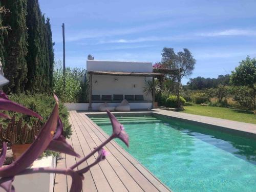 a swimming pool in front of a house at charming studio in the house of Envi's house in Sant Josep