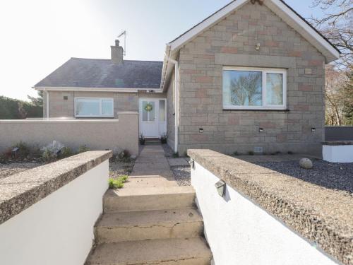 a brick house with stairs in front of it at Avemar in Buckie