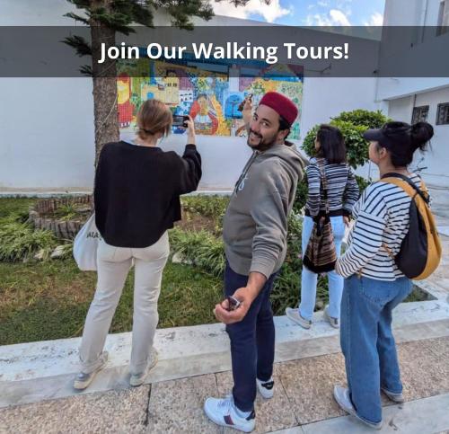 a man taking a picture of a group of people at Dar Hkaïem in Sousse