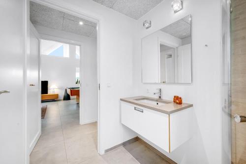 a kitchen with white cabinets and a sink at Dream House With Pool, Whirlpool And Activity Room in Ringkøbing