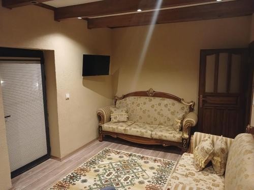 a living room with a couch in the corner of a room at ELEGANT HOUSE Cappadocia in Urgup