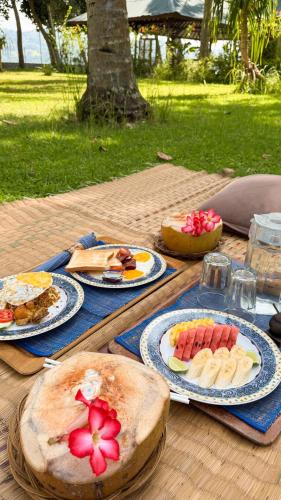 a table with plates of food on top of it at Belongas Bay Lodge LOMBOK in Blongas
