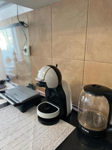 a coffee maker sitting on a counter next to a toaster at Apartments Tijana in Tivat