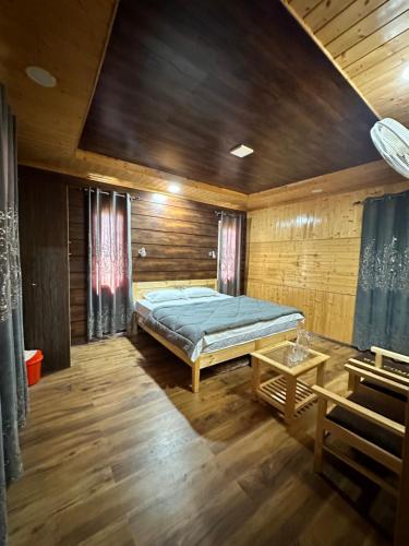 a bedroom with a bed in a wooden room at River View cottage in Anantnāg